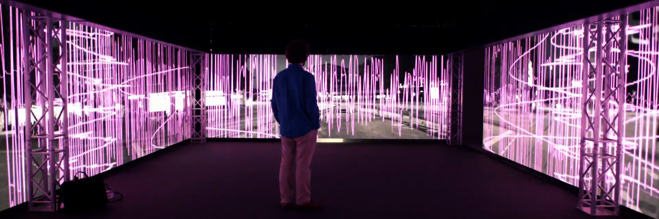 person surrounded by videowalls